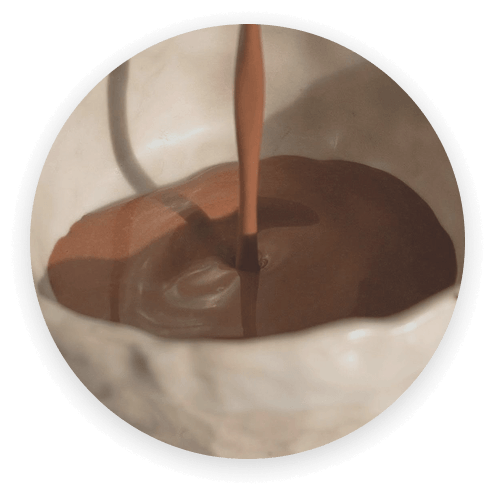 Ceremonial cacao being poured into a cup