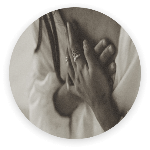 Hands held over the heart