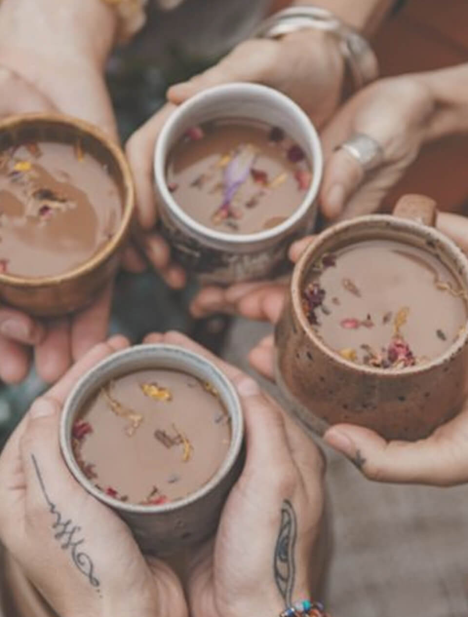 Women holding cups of ceremonial cacao