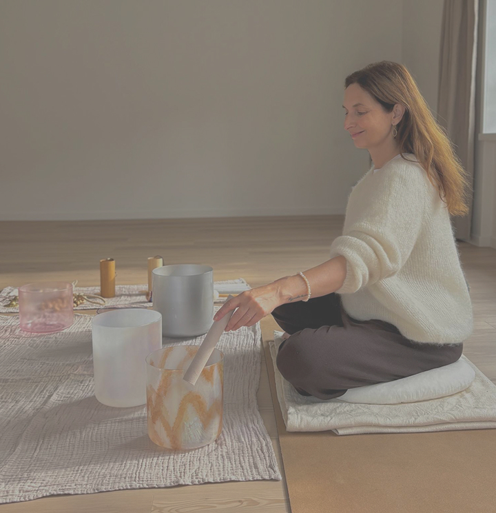 Gabi playing a crystal singing bowl