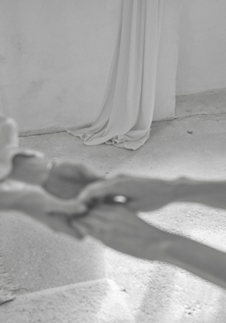 Gentle touch in a bright room, photographed in black and white