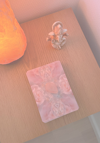 A salt lamp, a pink card and a small figurine