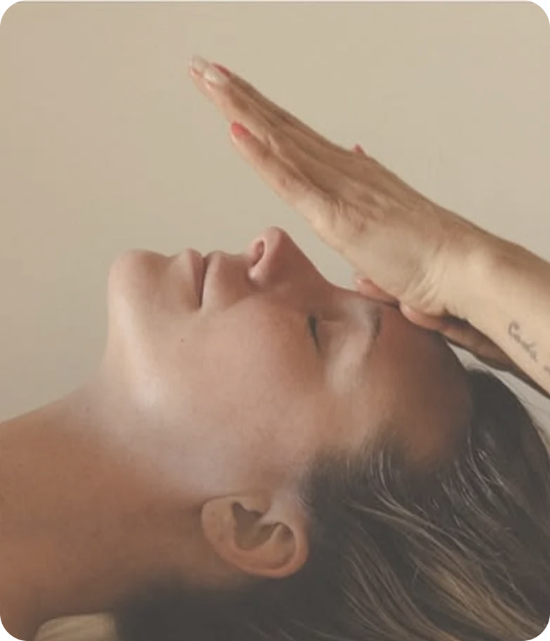 A woman receiving a gentle Reiki treatment